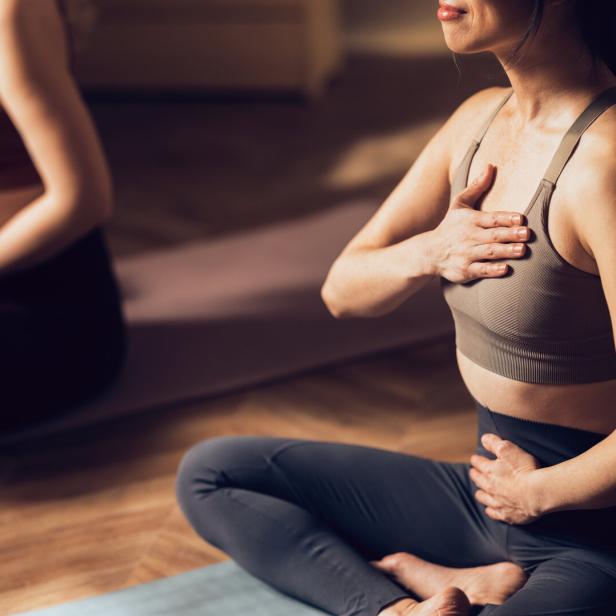 Women Practicing Yoga in a Calm Studio Environment for Wellness