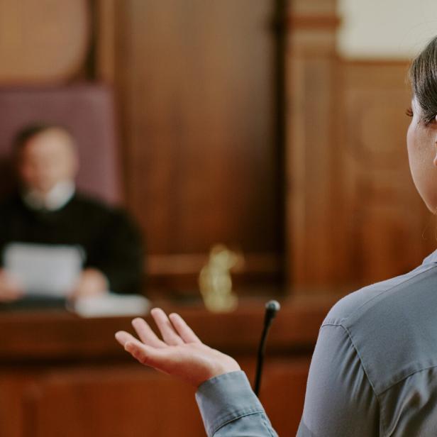 Young Adult Asian Woman Testifying in Courtroom during Legal Proceedings