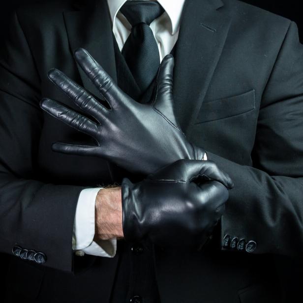 Mafia Hit Man Pulling on Leather Gloves