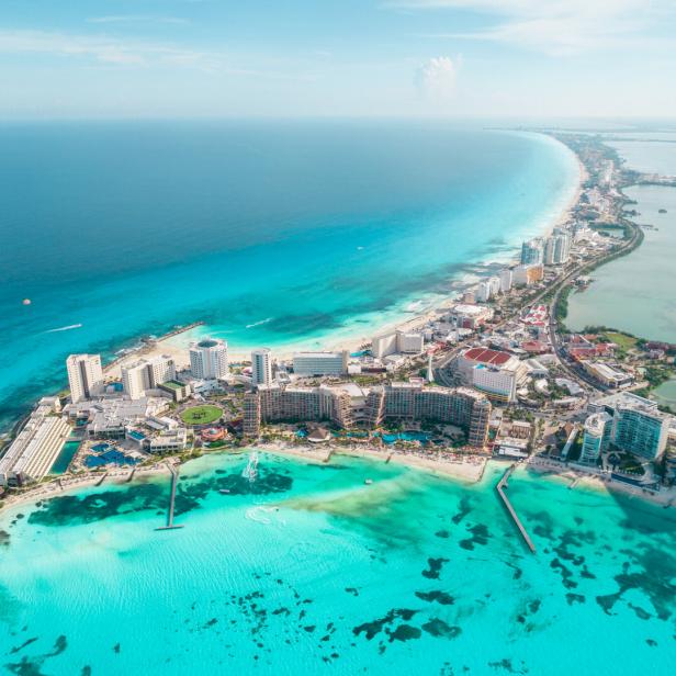 Aerial panoramic view of Cancun beach and city hotel zone in Mexico. Caribbean coast landscape of Mexican resort with beach Playa Caracol and Kukulcan road. Riviera Maya in Quintana roo region on Yucatan Peninsula