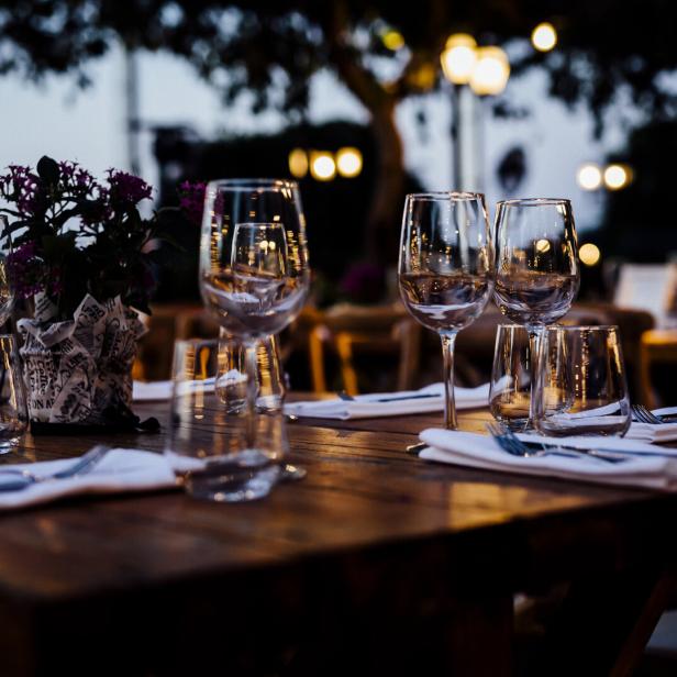 Luxury table settings for fine dining with and glassware, beautiful blurred  background. For events, weddings.