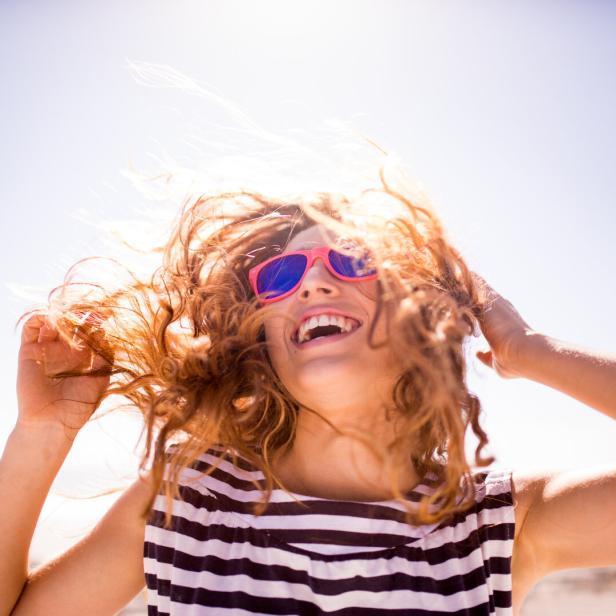 Cheerful laughing woman on the beach